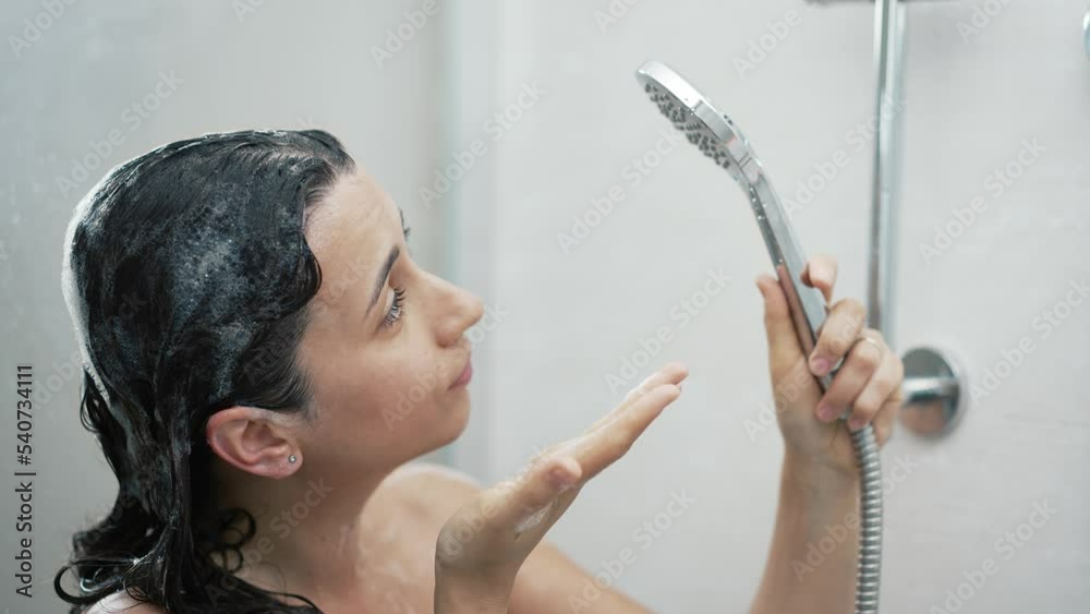Woman in shower without water. Turned off the water concept. Stock