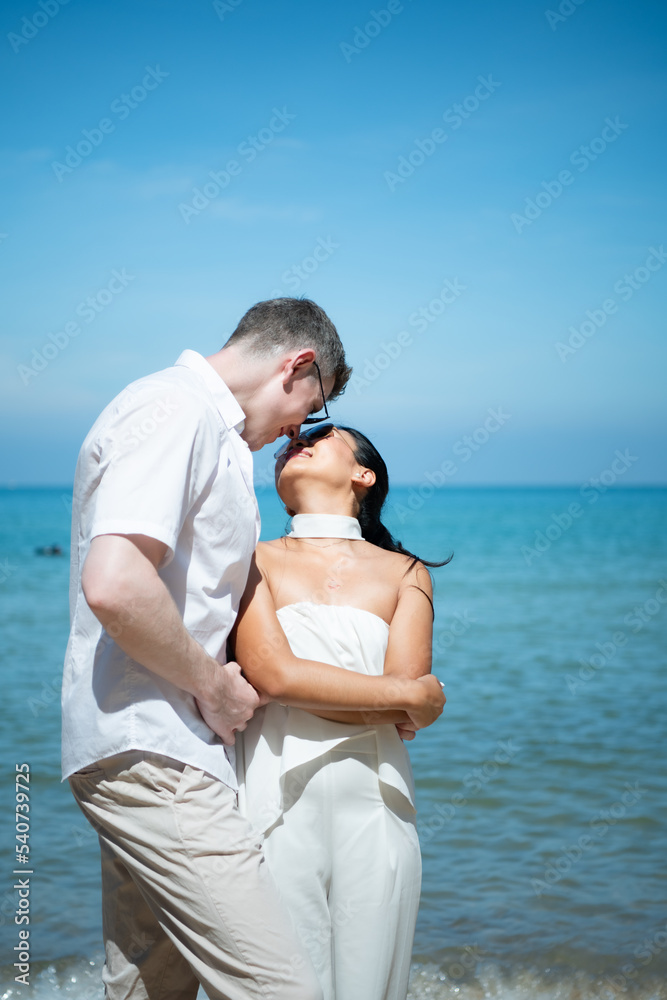 Interracial couple with the joy of traveling to the beautiful blue sea like the paradise Interracial couple with the joy of traveling to the beautiful blue sea like the paradise