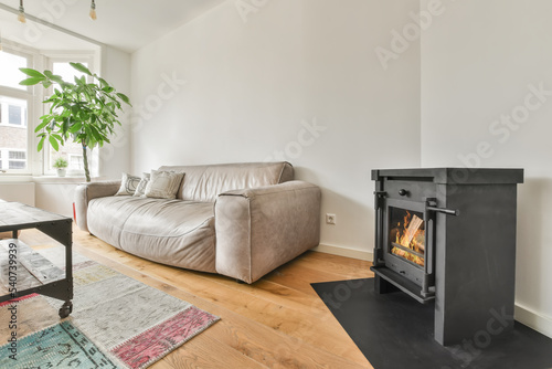 Modern Home With Furniture and fireplace next to a window photo