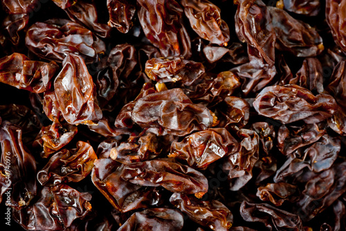 Close-up shot of freshly dried dark-colored raisins.