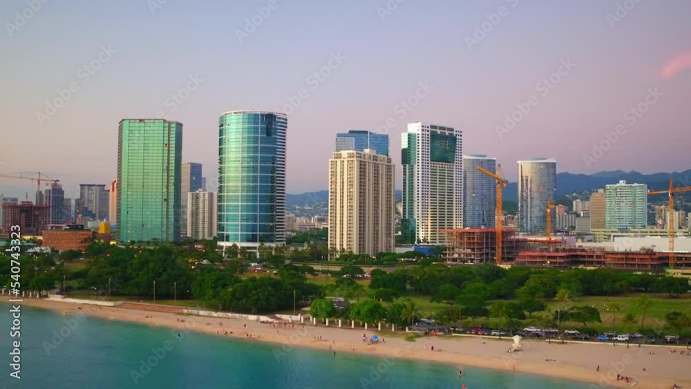 Aerial: Aerial Shot Of People At Beach In Modern City, Drone Flying Backwards Sea - Oahu, Hawaii Aerial: Aerial Shot Of People At Beach In Modern City, Drone Flying Backwards Sea - Oahu, Hawaii