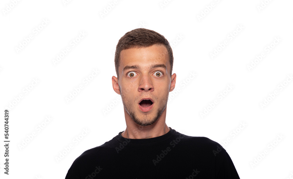 Surprised young man on a white background. The guy with his mouth open in surprise. Surprised young man on a white background. The guy with his mouth open in surprise.