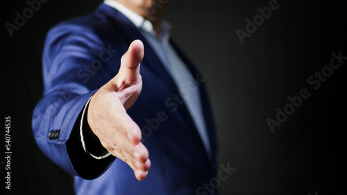 Man stretches out his hand for handshake closeup. Conducting business deals concept.