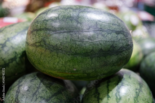 Watermelon fruit waiting to be cut and eaten immediately photo