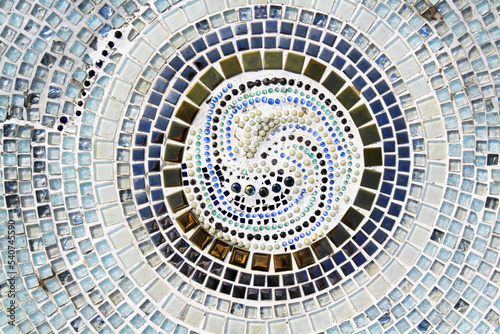 Colorful of mosaic tile floor for background. Art design wallpaper  Cracked  Shape or circle or round and Abstract. Blue  gray or grey  black  white and brown and blue tile fragments on wall.