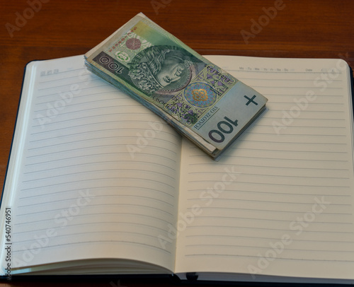 polish zloty currency bills on a notebook