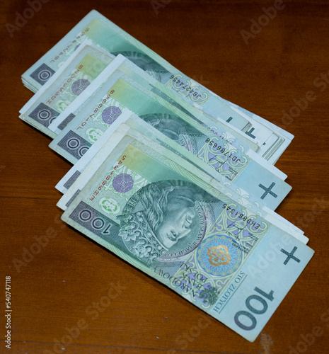 one hundreds polish zloty bills on table