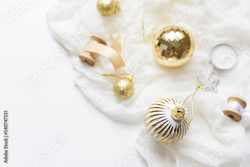 Christmas celebration concept composition with golden and white decoration on the table. Close up. Copy space