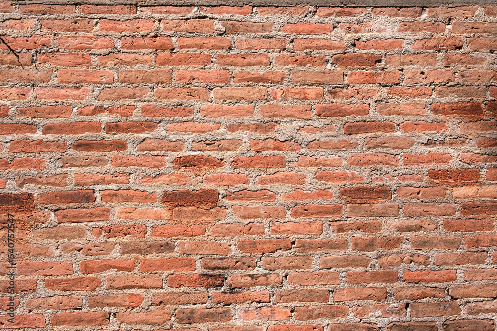 Naklejka premium abstract orange square brick block on cement wall textured and background. strong interiors house building image