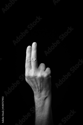 Hand demonstrating the Japanese sign language letter 'TO' or 'と' with copy space