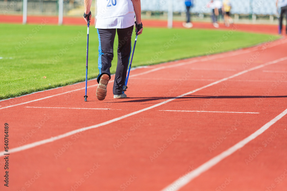 Athletes run and walk on the tracks in the stadium. the concept of sport and health.