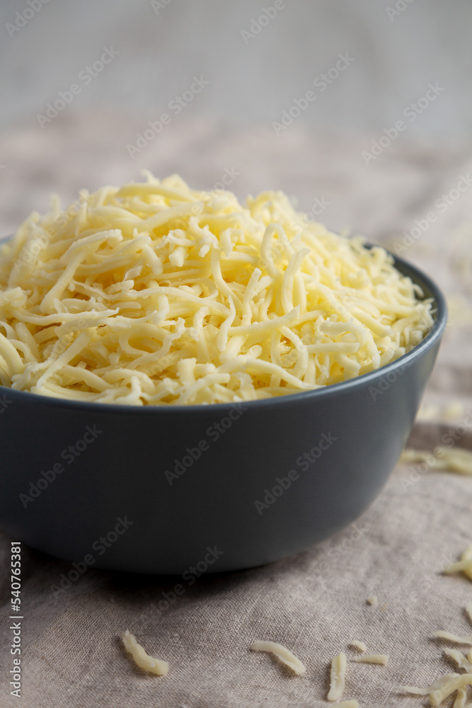Shredded Mozzarella Cheese in a Bowl, side view. Shredded Mozzarella Cheese in a Bowl, side view.