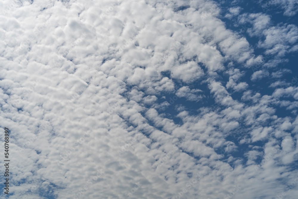 blue sky background with tiny clouds