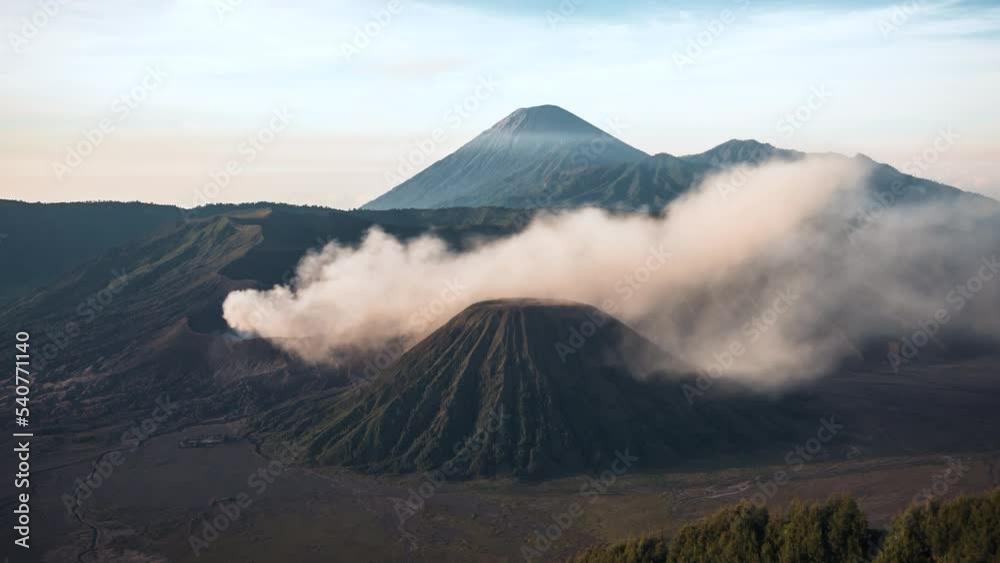 Zoom out time lapse view of the smoking crater of Mount Bromo (aka Gunung Bromo), an active volcano in East Java, Indonesia.
Zoom out time lapse view of the smoking crater of Mount Bromo (aka Gunung Bromo), an active volcano in East Java, Indonesia.