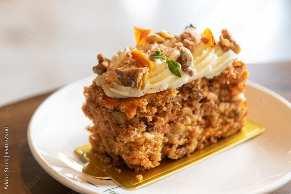 Carrot cake with walnuts, prunes and dried apricots with little edible flower. Carrot cake with walnuts, prunes and dried apricots with little edible flower.