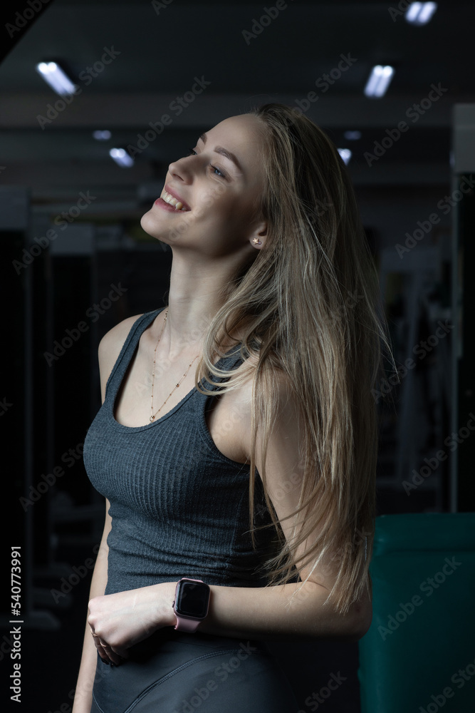 Portrait of a young beautiful blonde girl in sportswear in the gym. Portrait of a young beautiful blonde girl in sportswear in the gym.