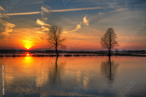 Landscape sunset or sundown river Narew Poland Europe spring time meadows under water 