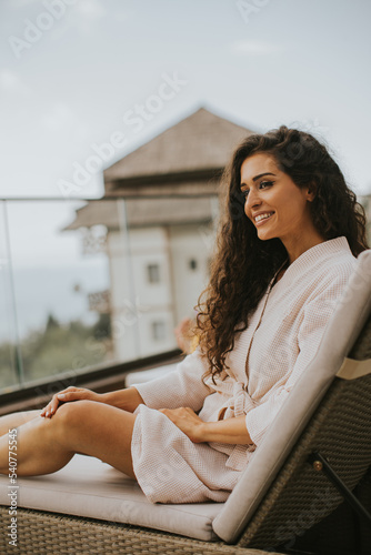 Young woman relaxing on bed...
