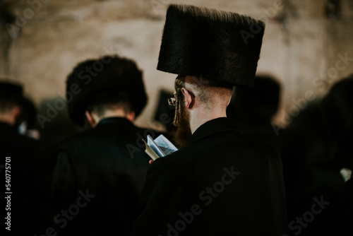 Orthodox Jewish man praying at the western wall photo