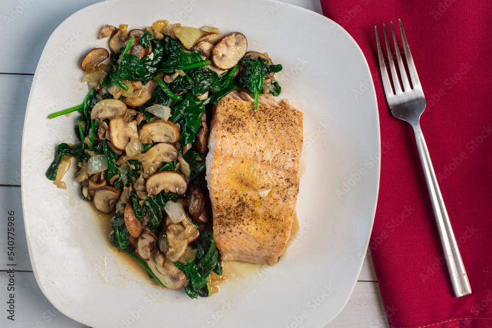 baked season salmon with a side of sauteed spinach and mushrooms baked season salmon with a side of sauteed spinach and mushrooms