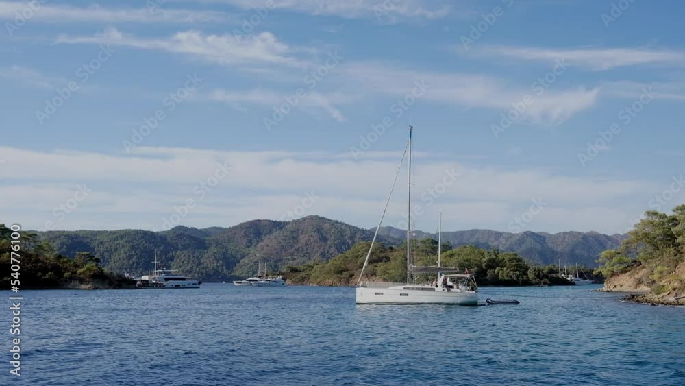 Beautiful bay with sailing boat, yacht in turquoise sea and mountains, luxury holidays or sailing regata sports. Beautiful bay with sailing boat, yacht in turquoise sea and mountains, luxury holidays or sailing regata sports.