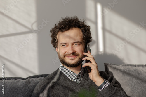 Obraz na płótnie The man smiles on the phone..Portrait of a business man who speaks on the phone. Serious young man solves working questions. w salonie
