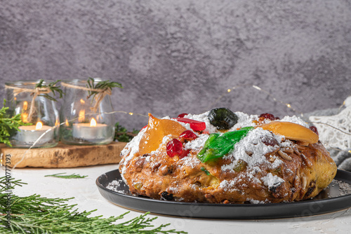 Bolo Rei or King's Cake is a traditional Xmas cake with fruits raisins nut and icing  on kitcthen countertop. Is made for Christmas, Carnavale or Mardi Gras
