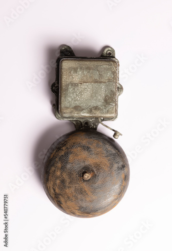 Rusty vintage electric alarm on white. The concept of old technologies. 