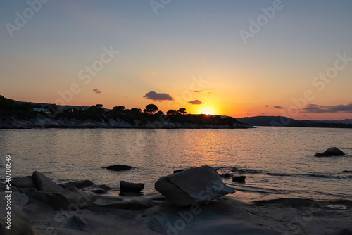 Panoramic view of coastline during sunset near Karydi beach, Vourvourou, Sithonia, Chalkidiki (Halkidiki), Greece, Europe. Vacation summer at Aegean Mediterranean Sea. Romantic atmosphere. Seascape photo