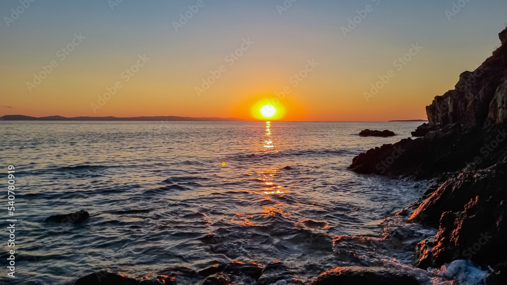 Obraz premium Panoramic view of coastline during sunset near Karydi beach, Vourvourou, Sithonia, Chalkidiki (Halkidiki), Greece, Europe. Vacation summer at Aegean Mediterranean Sea. Romantic atmosphere. Seascape