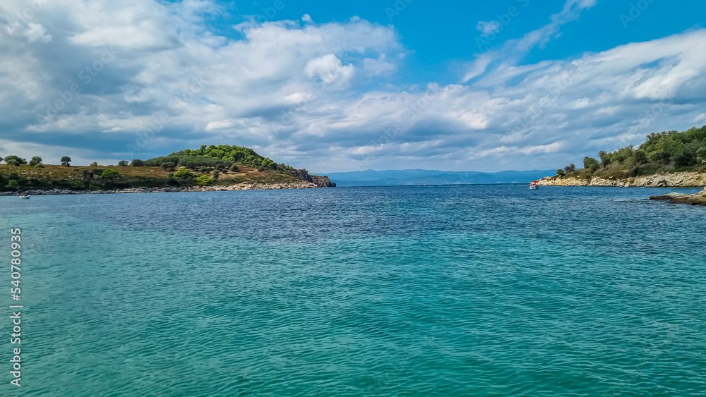 Panoramic view of the blue lagoon of Vourvourou on peninsula Sithonia, Chalkidiki (Halkidiki), Greece, Europe. Tropical crystals clear turquoise water. Summer vacation atmosphere in tropical paradise