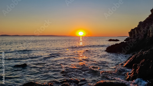Panoramic view of coastline during sunset near Karydi beach, Vourvourou, Sithonia, Chalkidiki (Halkidiki), Greece, Europe. Vacation summer at Aegean Mediterranean Sea. Romantic atmosphere. Seascape