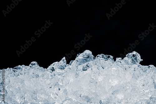 Shiny crushed ice heap on black background.