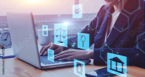 Businesswoman lawyer working with laptop computer phone and internet technology online giving business legal advice to clients, dealing with contracts and policies of labor law and justice concept.