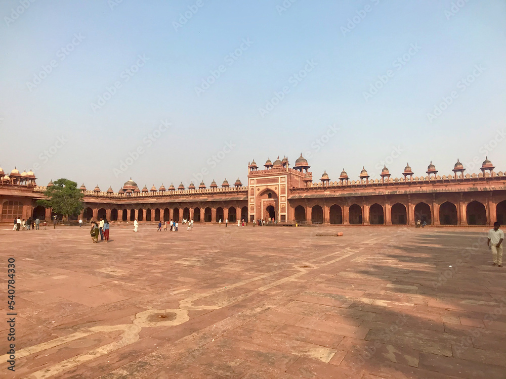 Fatehpur Sikri, India, November 2019 - A group of people standing in front of a building