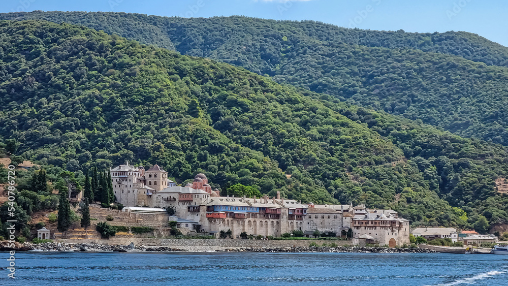 Scenic view from boat on Xenophontos monastery at Mount Athos in Autonomous Monastic State of Holy Mountain, Chalkidiki, Central Macedonia, Greece, Europe. Holy Eastern Orthodox terrain of Again Oros