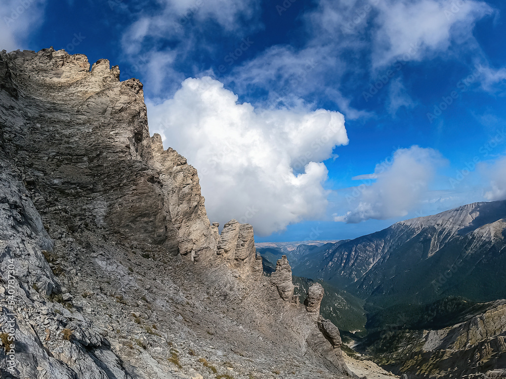 Climbing on mystical foggy hiking trail leading to Mount Olympus (Mytikas, Skala, Stefani, Skolio), Mt Olympus National Park, Macedonia, Greece, Europe. Scenic view of cloud covered cliffs and ridges