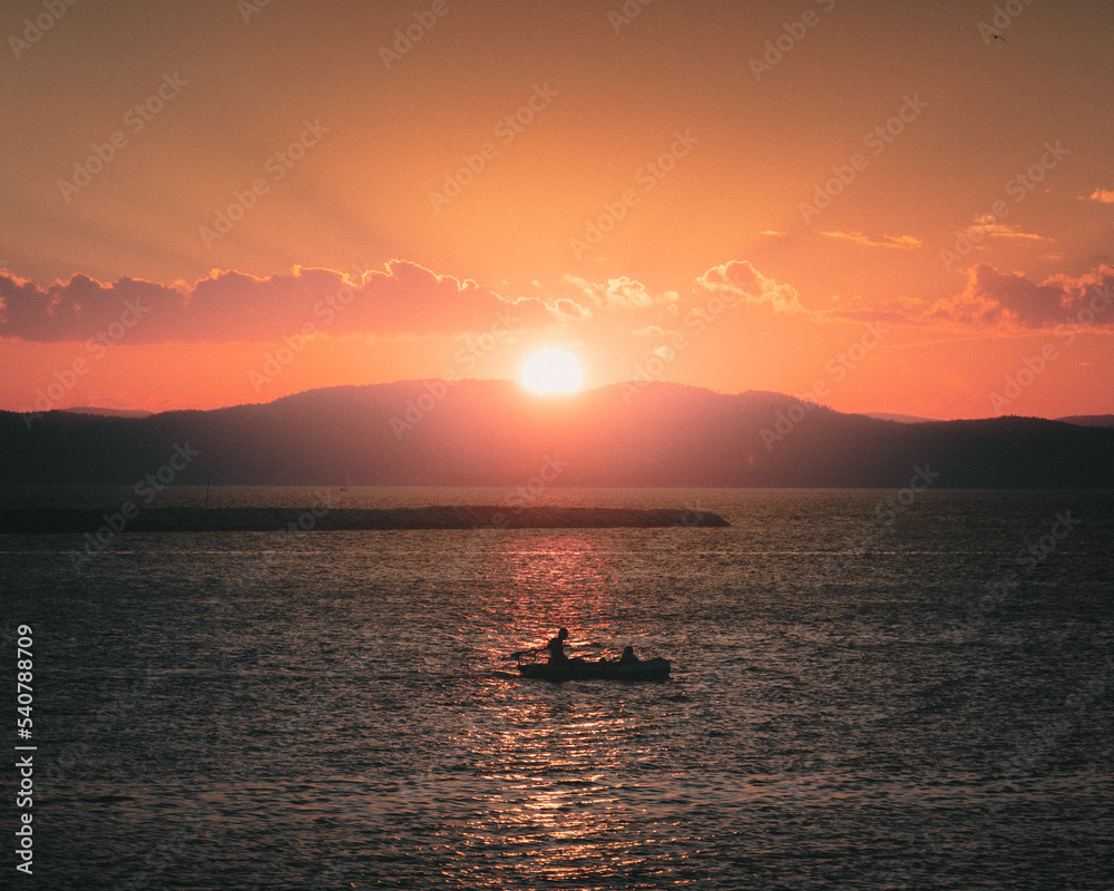 Sunset over Lake Champlain taken from Burlington, Vermont with a small boat center frame
