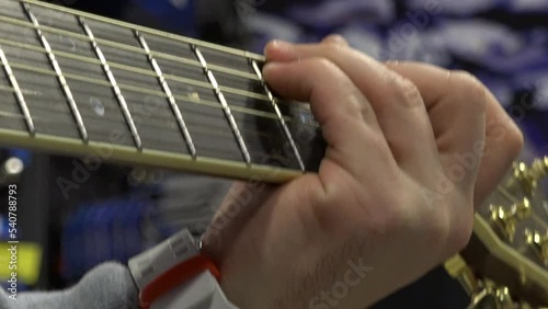 Close-up of the hands on the guitar neck