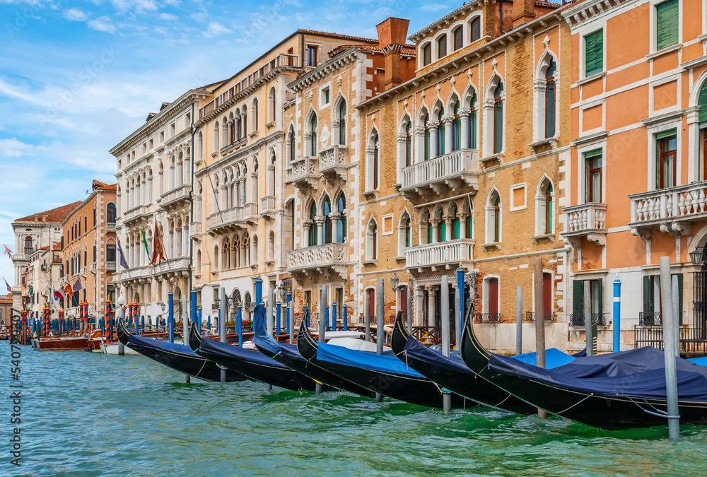 Gondolas moored on Grand Canal at traditional Venetian buildings, Venice, Italy.