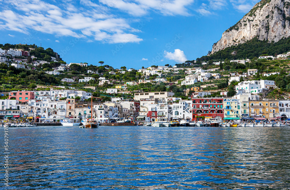 Italy, island of Capri. Beautiful view of the island of Capri from the board of a pleasure yacht in summer sunny weather. Capri is a popular seaside resort in the Italian province of Naples.