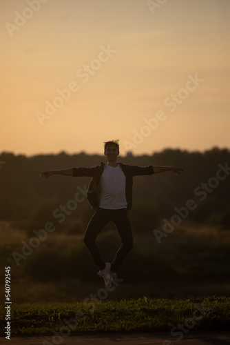 Summer activity and energy. Ballet dancer. Handsome man workout and stretching. fitness Coach and health. Sport and yoga. Pilates for man. Nature background. Young man. Ballet dancer. Green grass. 