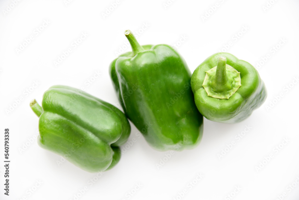 Juicy green and yellow pepper fruits on a white background. Beautiful shiny and delicious pepper. Juicy green and yellow pepper fruits on a white background. Beautiful shiny and delicious pepper.