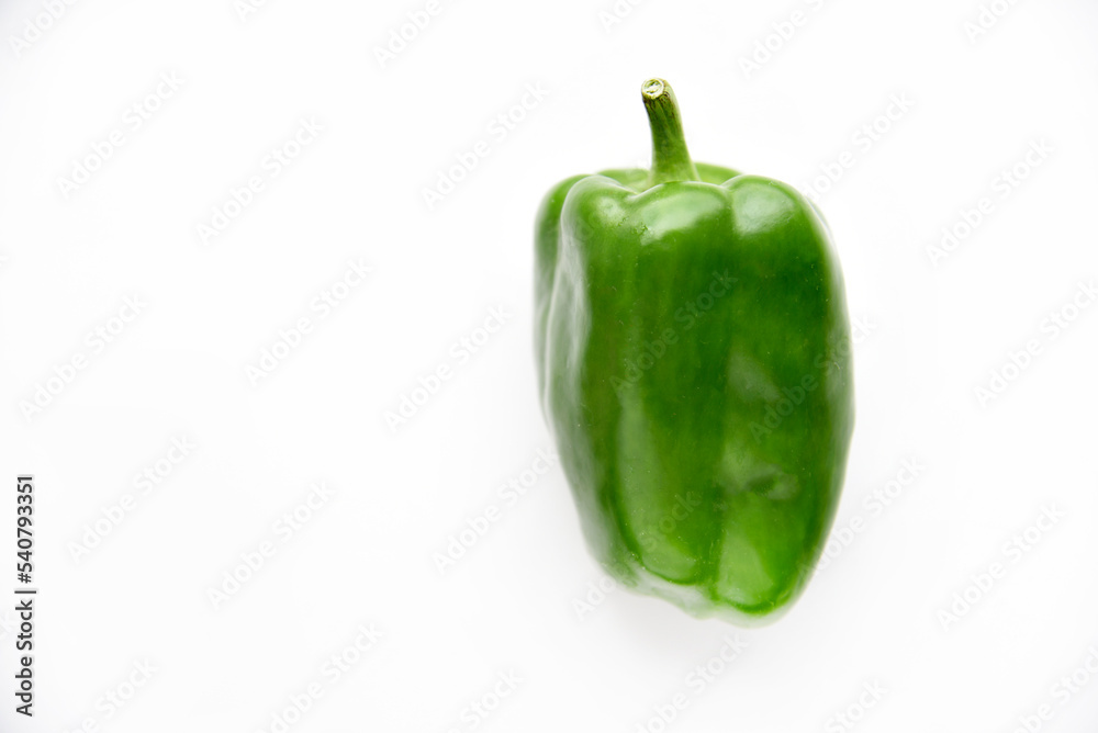 Juicy green and yellow pepper fruits on a white background. Beautiful shiny and delicious pepper. Juicy green and yellow pepper fruits on a white background. Beautiful shiny and delicious pepper.