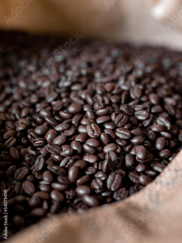 Close up of fresh dark roasted coffee inside of a sack