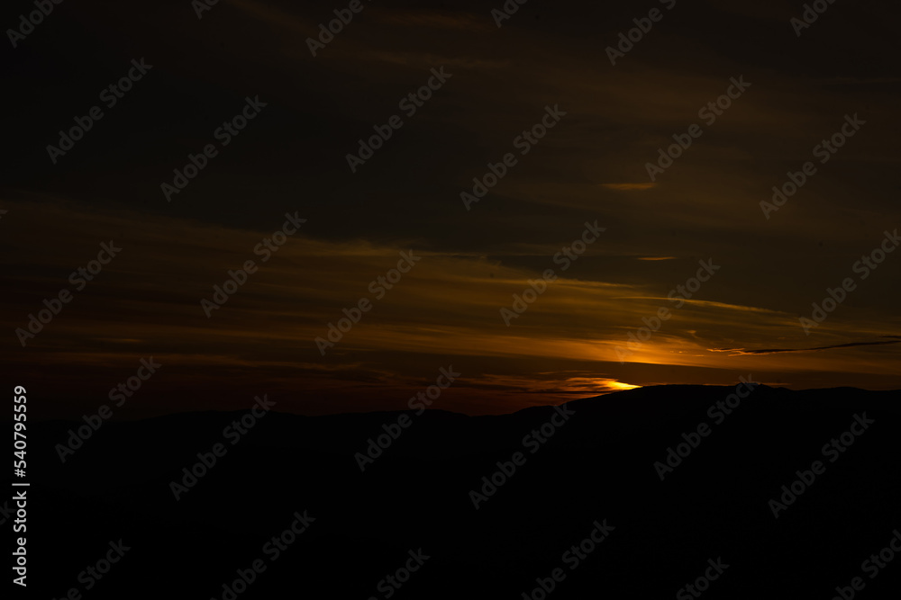 Sunset in mountains in summer landscape