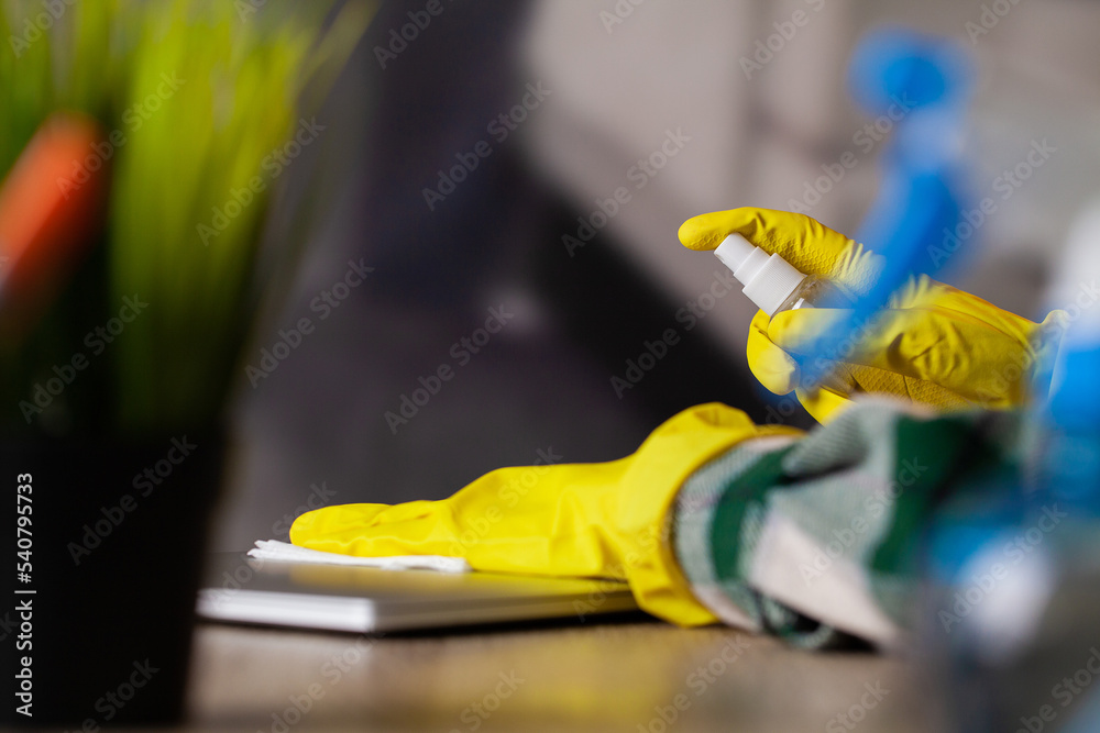 Close-up Of Woman Hand Cleaning Laptop At Office
