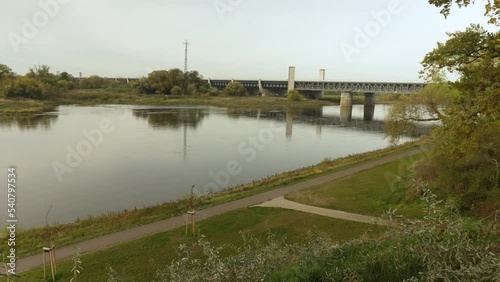 Wide shot with a view of a trough bridge, which is filled with water and crosses a natural river as a shipping lane