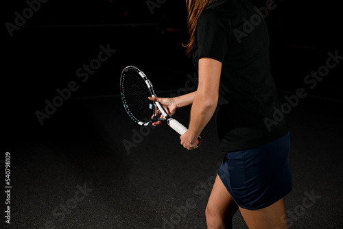 selective focus on tennis racket in the hands of woman tennis player.