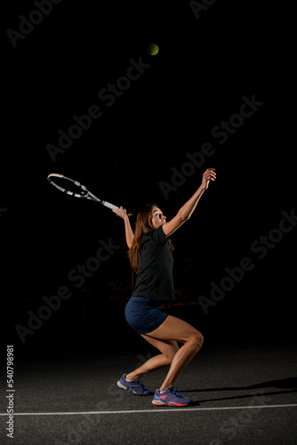view on woman with racket in special pose which preparing to hit ball above her head